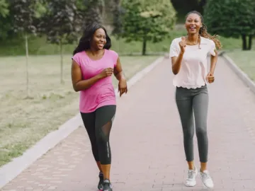 Twee vrouwen beginnen met hardlopen in een zonnig park