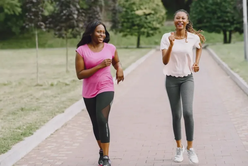Twee vrouwen beginnen met hardlopen in een zonnig park